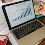 A close-up view of a laptop displaying business analytics and revenue charts.