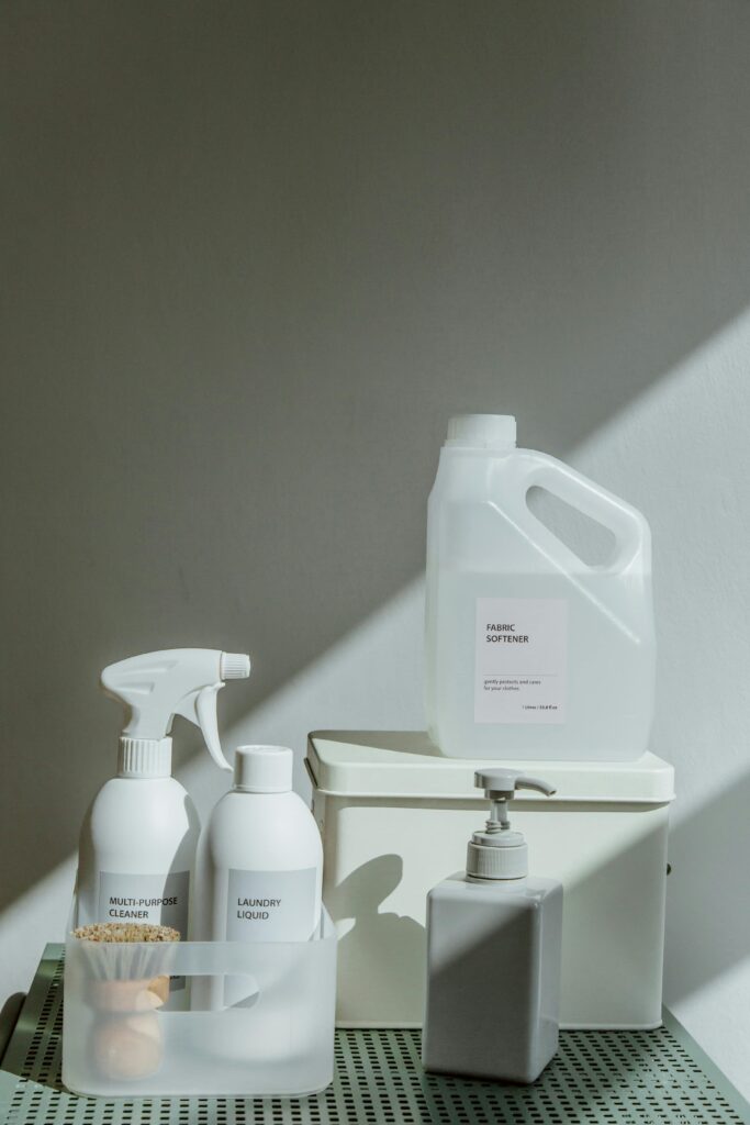 pexels-photo-10566513-10566513 Elegant arrangement of cleaning products with natural sunlight casting shadows, highlighting a minimalist aesthetic.