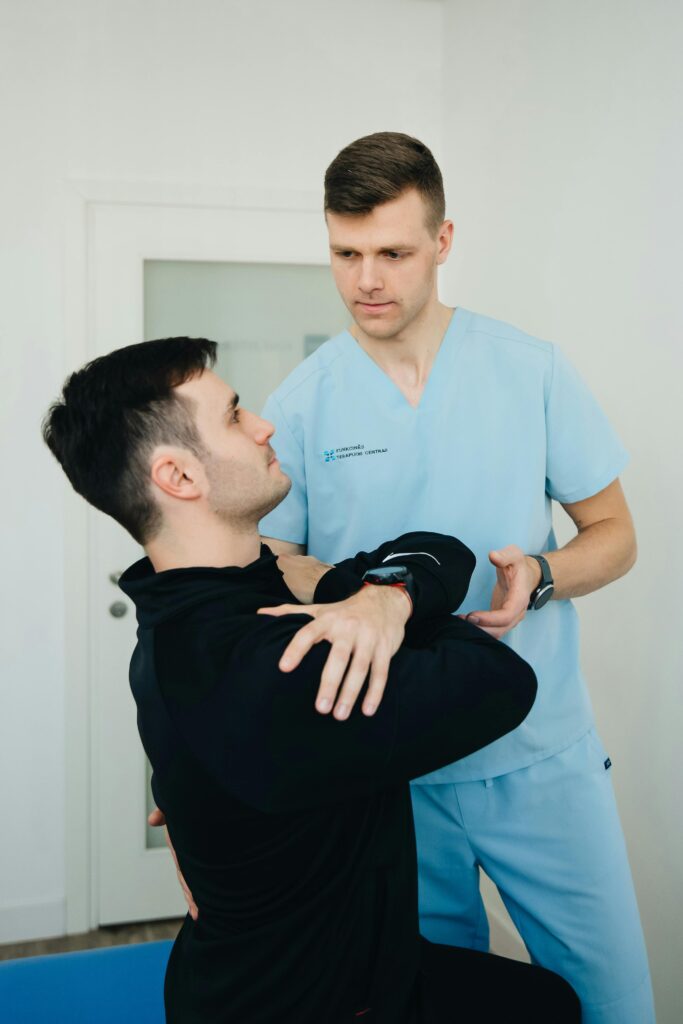 pexels-photo-20860583-20860583 Physiotherapist assists a patient in therapeutic exercises indoors.